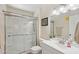 Bathroom featuring a glass-enclosed shower, white vanity, and neutral decor at 10431 W Roundelay Cir, Sun City, AZ 85351