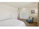 Bedroom with a large closet, cozy chair, and neutral carpet at 10431 W Roundelay Cir, Sun City, AZ 85351