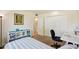 Bedroom with a large storage unit, desk, and neutral carpet at 10431 W Roundelay Cir, Sun City, AZ 85351
