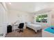 Bright bedroom featuring a desk, single bed, and large window at 10431 W Roundelay Cir, Sun City, AZ 85351