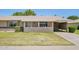 Charming single-story home with well-maintained lawn and colorful flowerpots at 10431 W Roundelay Cir, Sun City, AZ 85351