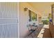Covered patio with seating area and access to the front door at 10431 W Roundelay Cir, Sun City, AZ 85351