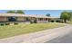 Inviting single-story home with a lush front lawn and neatly trimmed landscaping at 10431 W Roundelay Cir, Sun City, AZ 85351