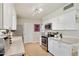 Clean kitchen with white cabinets, stainless steel appliances, and neutral countertops at 10431 W Roundelay Cir, Sun City, AZ 85351