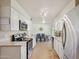 Spacious kitchen with white cabinets, stainless steel appliances, and view to dining room at 10431 W Roundelay Cir, Sun City, AZ 85351
