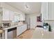 Well-lit kitchen with white cabinets, stainless steel appliances, and neutral countertops at 10431 W Roundelay Cir, Sun City, AZ 85351