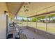 Cozy lanai with seating, offering serene views of the lush green lawn and landscaping at 10431 W Roundelay Cir, Sun City, AZ 85351