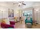 Bright living room featuring tile flooring, comfortable seating, and large window at 10431 W Roundelay Cir, Sun City, AZ 85351