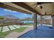 Inviting backyard oasis featuring a fire pit, artificial grass, and a covered patio with ceiling fans at 1101 W Oleander Ave, Queen Creek, AZ 85140