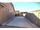 Private backyard featuring a concrete driveway leading to a gated fence, and block wall creating a secluded space at 1101 W Oleander Ave, Queen Creek, AZ 85140