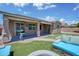 Outdoor patio with ceiling fans, artificial turf, and custom outdoor seating surrounding fire pit at 1101 W Oleander Ave, Queen Creek, AZ 85140