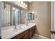 Bathroom featuring double sinks, white countertops, and a large mirror at 1101 W Oleander Ave, Queen Creek, AZ 85140