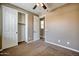 Bedroom with neutral carpet, ceiling fan, and a closet at 1101 W Oleander Ave, Queen Creek, AZ 85140
