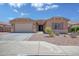 Charming single-story home with a two-car garage, desert landscaping and welcoming entrance at 1101 W Oleander Ave, Queen Creek, AZ 85140