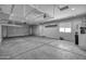 Spacious garage featuring high ceilings, overhead storage racks, and ample room for vehicles and projects at 1101 W Oleander Ave, Queen Creek, AZ 85140