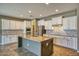 Modern kitchen featuring white cabinetry, stainless steel appliances, and a granite-topped kitchen island at 1101 W Oleander Ave, Queen Creek, AZ 85140