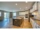 Open-concept kitchen featuring granite countertops, modern appliances, and stylish tile flooring throughout at 1101 W Oleander Ave, Queen Creek, AZ 85140