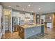 Modern kitchen featuring granite countertops, stainless steel appliances, and custom cabinets for storage at 1101 W Oleander Ave, Queen Creek, AZ 85140
