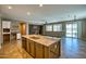 Open floor plan with large kitchen island, view to the living room, and sliding glass doors to backyard at 1101 W Oleander Ave, Queen Creek, AZ 85140