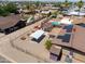 Aerial view of homes with pools and a fenced yard with a carport and shed at 1109 N Walnut Dr, Casa Grande, AZ 85122