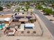 Aerial view of a residence with solar panels, a carport, and a shed in the fenced yard at 1109 N Walnut Dr, Casa Grande, AZ 85122