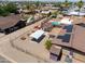 Aerial view of homes with pools and a fenced yard with a carport and shed at 1109 N Walnut Dr, Casa Grande, AZ 85122