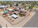 Aerial view of a residence with solar panels, a carport, and a shed in the yard at 1109 N Walnut Dr, Casa Grande, AZ 85122