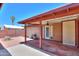 Backyard with brick patio and covered porch presents an inviting space for outdoor entertainment and relaxation at 1109 N Walnut Dr, Casa Grande, AZ 85122