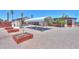Backyard view of the covered carport provides ample parking and additional storage and garden beds at 1109 N Walnut Dr, Casa Grande, AZ 85122