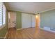 Open bedroom with wood-look floors and a private ensuite bathroom with accessible features at 1109 N Walnut Dr, Casa Grande, AZ 85122