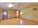 Large bonus room with brick accent wall, neutral paint and laminate floors at 1109 N Walnut Dr, Casa Grande, AZ 85122