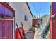 Outdoor shed with a wheelbarrow and various gardening items offers practical storage and convenience at 1109 N Walnut Dr, Casa Grande, AZ 85122