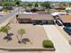 Aerial view of a brick home with a large front yard and a long driveway at 1109 N Walnut Dr, Casa Grande, AZ 85122
