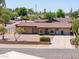 Charming single-story brick home with manicured landscaping, a spacious driveway, and a welcoming facade at 1109 N Walnut Dr, Casa Grande, AZ 85122