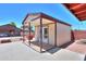 Cozy shed with a covered porch, with lighting and a full-glass door offers additional storage space at 1109 N Walnut Dr, Casa Grande, AZ 85122