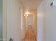 Well-lit hallway featuring wood-look flooring and access to multiple rooms at 1109 N Walnut Dr, Casa Grande, AZ 85122