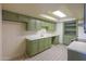Charming kitchen featuring ample cabinet space, tile flooring, and modern lighting at 1109 N Walnut Dr, Casa Grande, AZ 85122