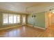 Bright living room with wood flooring, large windows, and ceiling fan at 1109 N Walnut Dr, Casa Grande, AZ 85122