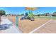 Playground featuring a slide, stairs and various climbing apparatus set on a mulch ground cover at 1109 N Walnut Dr, Casa Grande, AZ 85122