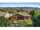 Aerial shot of backyard featuring a pool, grass, desert landscaping, and mountain views at 1506 E Branham Ln, Phoenix, AZ 85042