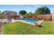 Backyard oasis featuring a pool, lush landscaping, and a patio, perfect for outdoor entertaining and relaxation at 1506 E Branham Ln, Phoenix, AZ 85042