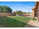 Spacious backyard with a well-maintained lawn and view of the enclosed pool area at 1506 E Branham Ln, Phoenix, AZ 85042