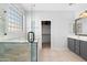 Bright bathroom with dual sink vanity, walk-in shower, and a separate toilet room at 1506 E Branham Ln, Phoenix, AZ 85042