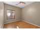 Neutral bedroom featuring a ceiling fan, window with blinds, and beautiful laminate flooring at 1506 E Branham Ln, Phoenix, AZ 85042