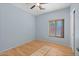 Neutral bedroom featuring a ceiling fan, window with blinds, and beautiful laminate flooring at 1506 E Branham Ln, Phoenix, AZ 85042