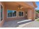 Covered patio with stylish flooring, a ceiling fan, and seamless transition to the backyard, perfect for entertaining at 1506 E Branham Ln, Phoenix, AZ 85042