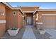 Inviting front entrance with stone pillars, desert landscaping, and paver walkway at 1506 E Branham Ln, Phoenix, AZ 85042