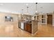 Kitchen island with granite countertops, sink, dishwasher, and wood cabinets, perfect for meal preparation and entertaining at 1506 E Branham Ln, Phoenix, AZ 85042