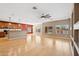 Spacious open concept living room with wood flooring, large windows, and a ceiling fan at 1506 E Branham Ln, Phoenix, AZ 85042