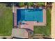 Aerial view of a private pool with a red umbrella, surrounded by greenery at 1506 E Branham Ln, Phoenix, AZ 85042
